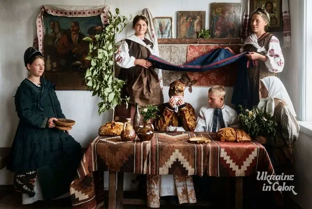 Cossack Mamai beside icons on the wall of a village house