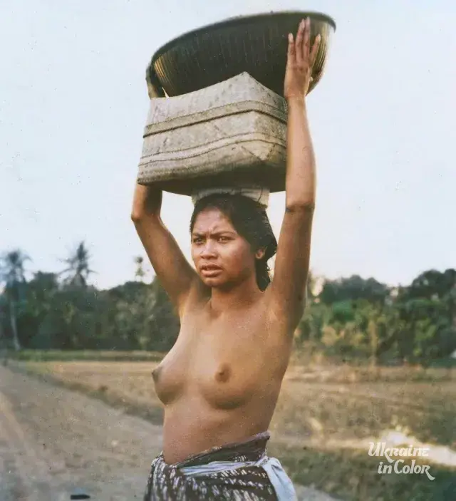 A half-naked girl with a basket on her head