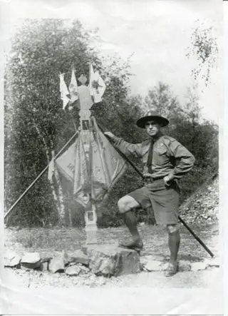Scout camp: a man by a tent